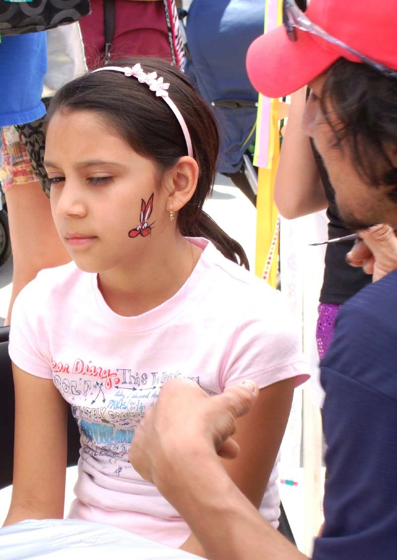 photo of girl getting her face painted